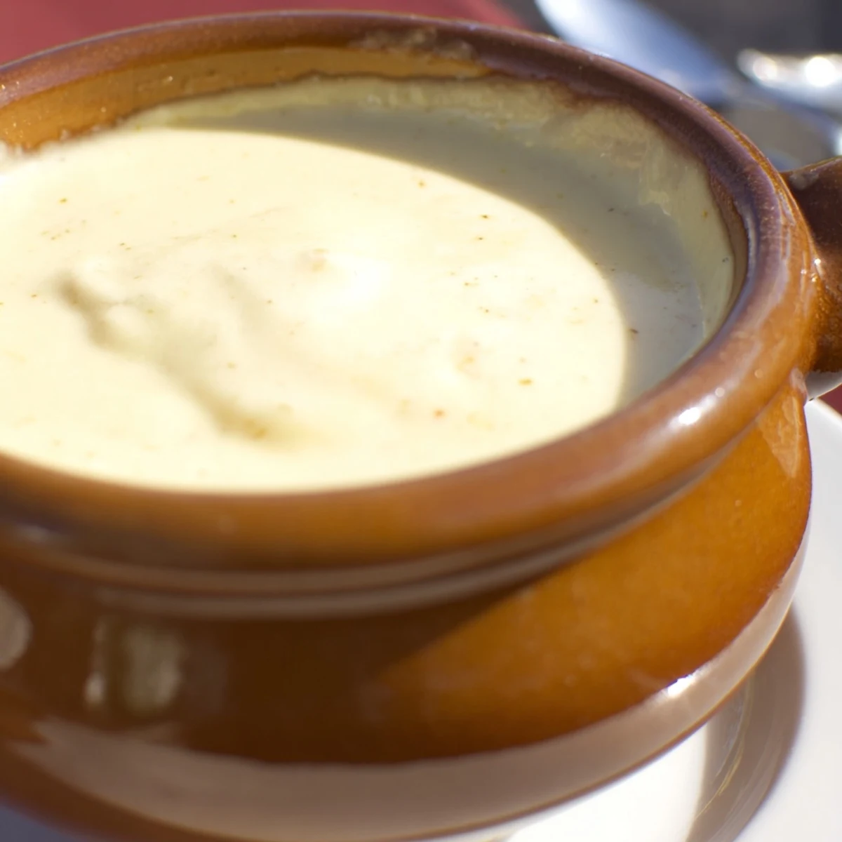 Melted Swiss Cheese Fondue, with crusty bread for dipping, offering rich, cheesy flavors.