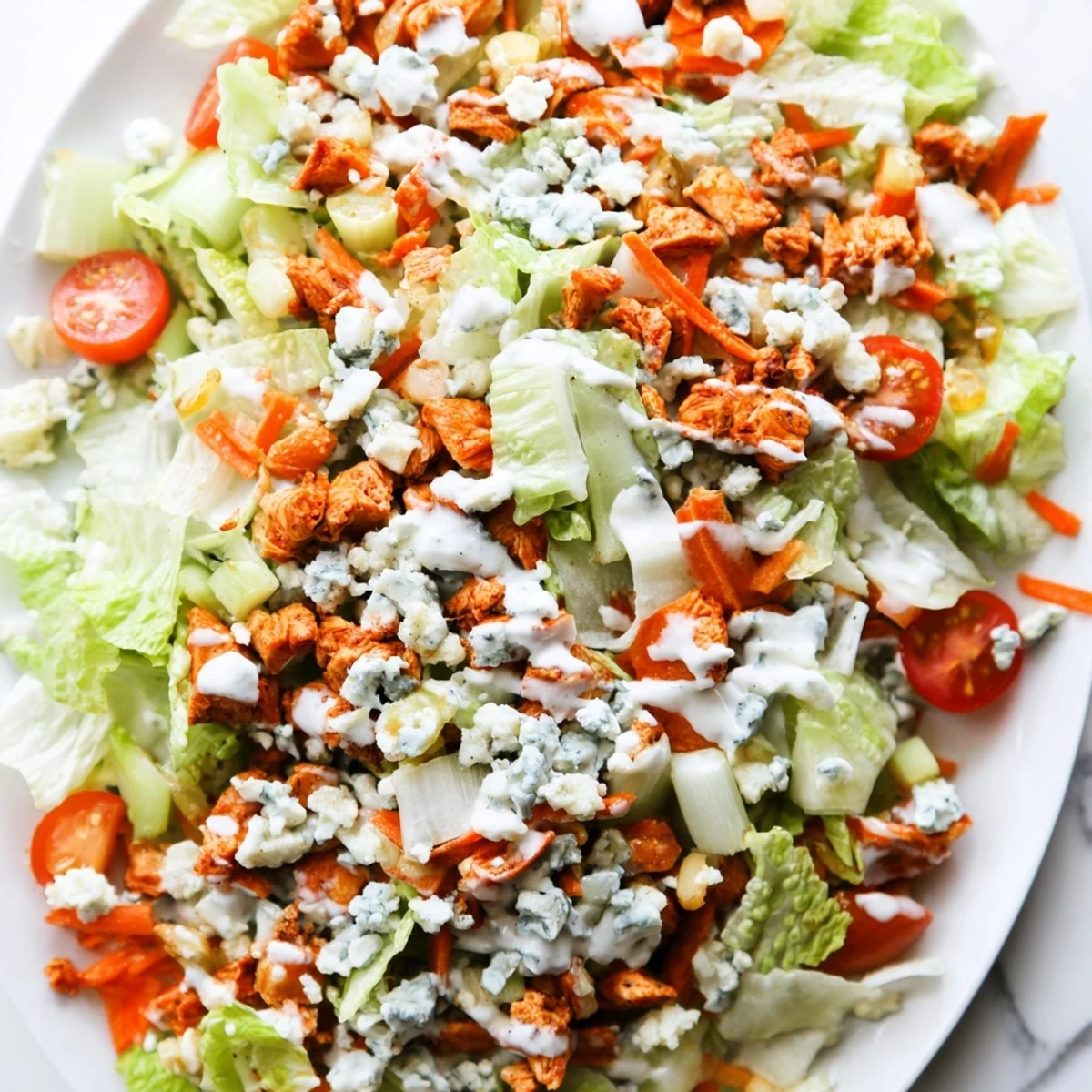 Buffalo Chicken Chopped Salad served with crisp celery, red onion, and a drizzle of zesty ranch.