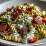 Creamy avocado ranch pasta tossed with juicy tomatoes, crunchy bacon, and crisp romaine lettuce in a flavorful, easy-to-make dish.