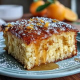 Slices of bright orange cake reveal a tender, fragrant texture, perfect for a refreshing dessert.  