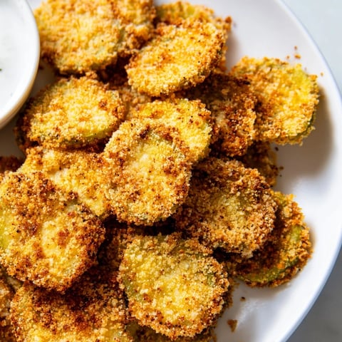 Golden-brown Crispy Fried Pickles, hot from the air fryer, are perfect for dipping in cool ranch.