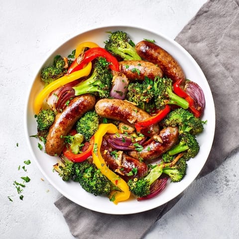 Rustic Simple Sheet-Pan Sausage with tender roasted broccoli and colorful bell peppers, ideal for dinner.