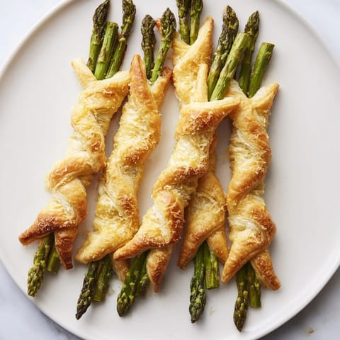 Delicate Star Shaped Asparagus Bundle Wraps, ready to serve as a beautiful, warmly plated vegetarian appetizer.