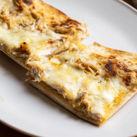 Crispy edges of savory Leftover Pizza Grilled Cheese with melted cheese oozing from the center.