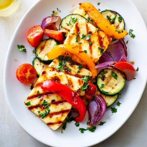 Sizzling halloumi cheese steaks fresh off the grill, garnished with parsley and served with bright lemon wedges for squeezing.