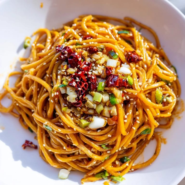 Savory Garlic Chili Oil Noodles with scallions and sesame seeds, a quick vegan weeknight meal.